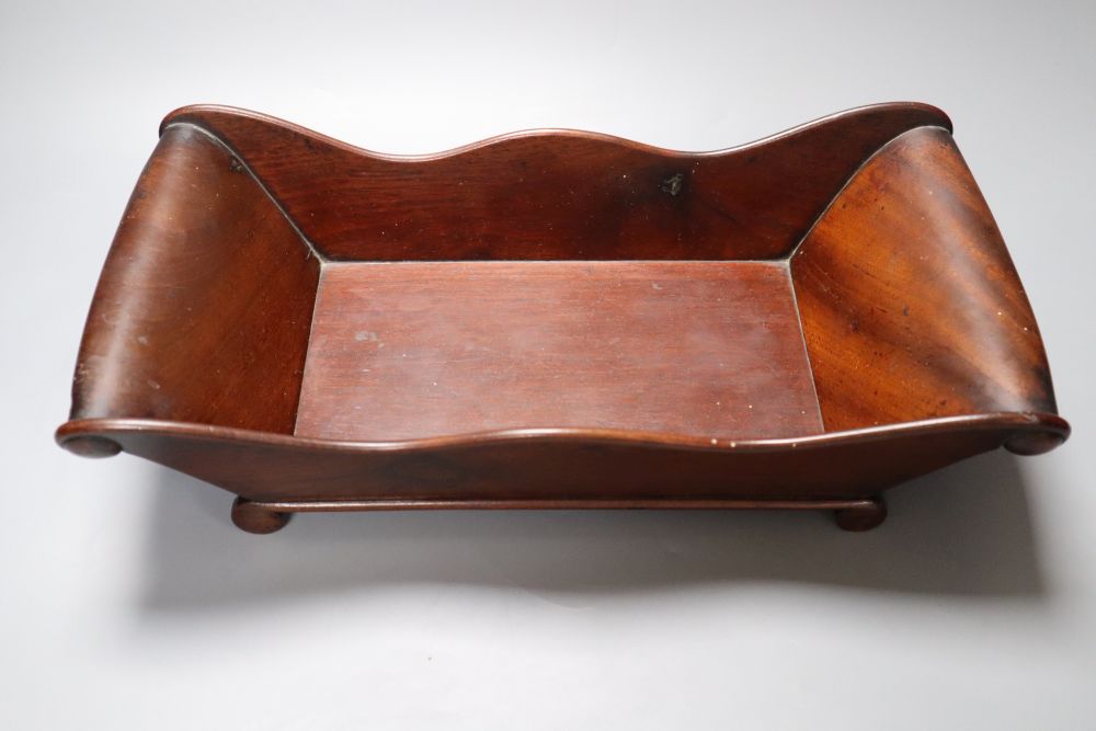 A Victorian mahogany cheese coaster, with scroll ends, 36 x 19cm